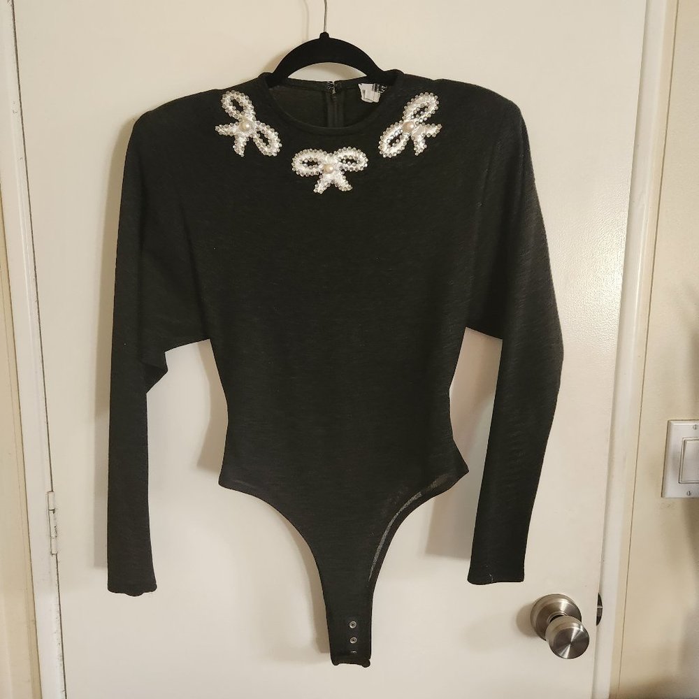 Vintage body suit with snap crotch and shoulder pads. Size Small